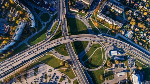 Aerial view of a busy highway surrounded by homes and apartment buildings.