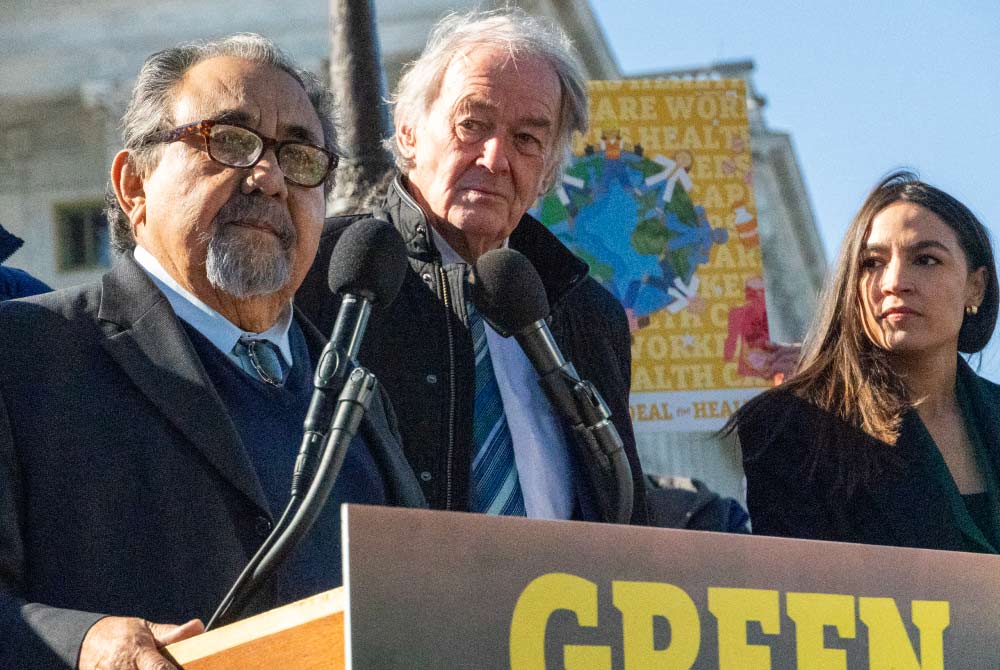 Representative Grijalva speaking at a podium during a press conference.